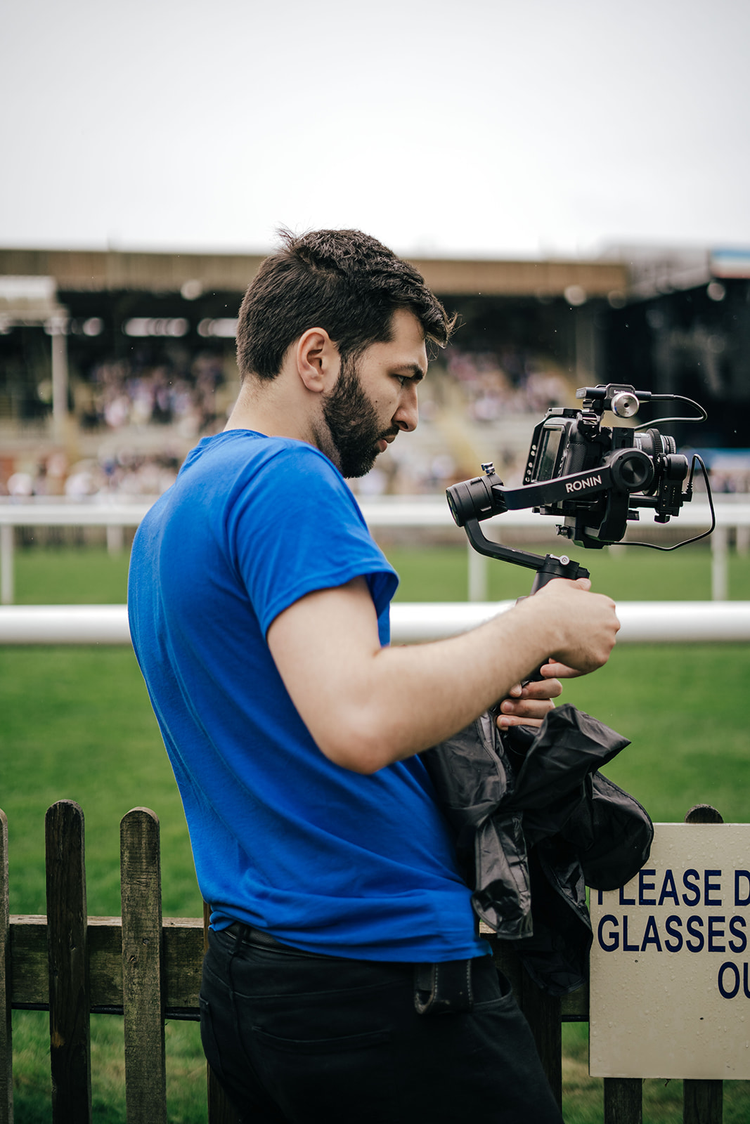Man filming horse racing