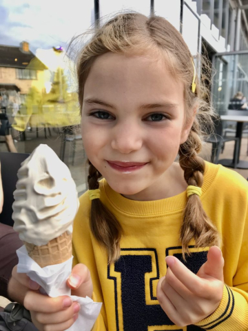 Emily smiling with an ice cream in her hand